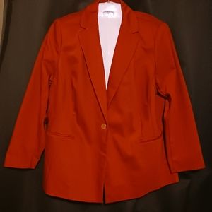Red blazer with a red button trimmed with gold on each sleeve and the front.